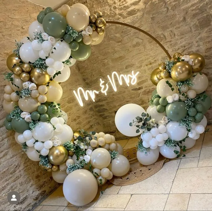 Arco per matrimonio con palloncini verde salvia, bianchi e oro e scritta Mr and Mrs.